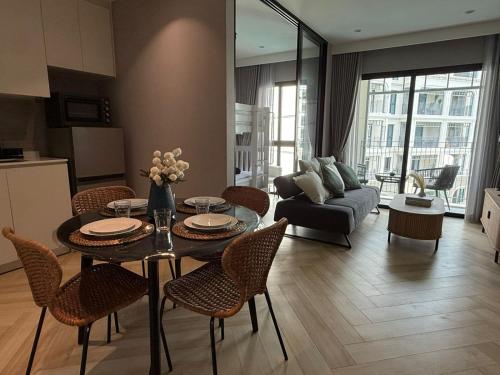 a living room with a table and chairs at The Legendary Bang Tao 2-bedrooms apart #402 in Bang Tao Beach