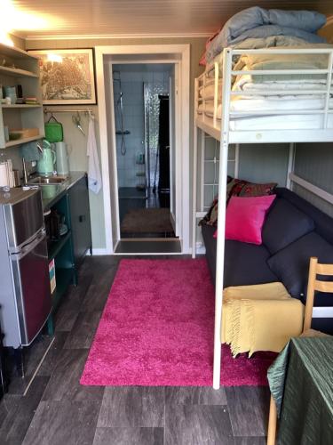 a living room with a bunk bed and a couch at Fagertun in Lillesand