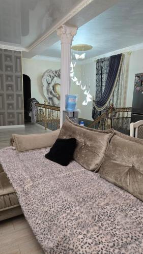 a bed with pillows on it in a room at Aura in Dzerzhinskoye