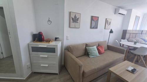 a living room with a couch and a table at Estudio Bellavista La Colina in Torremolinos