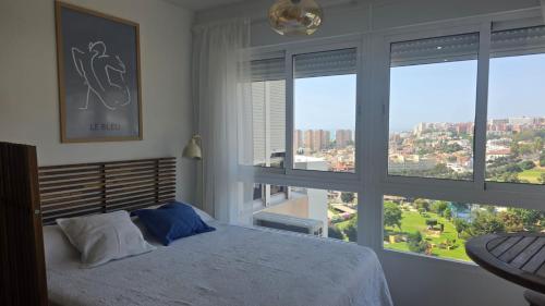 a bedroom with a bed and a large window at Estudio Bellavista La Colina in Torremolinos