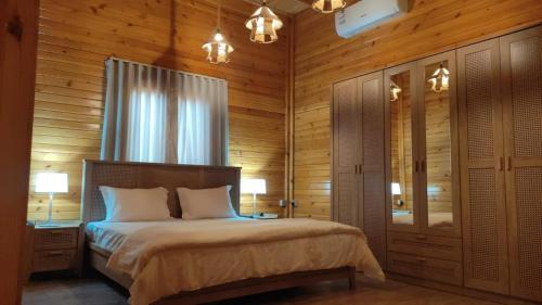 a bedroom with a bed and a window and lights at أكواخ واستراحه ريف عسير in Abha