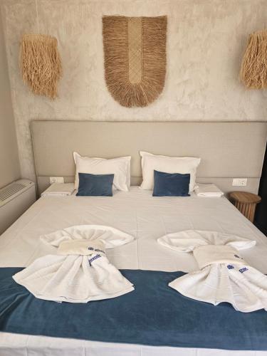 a bed with two towels on top of it at Византия in Sozopol