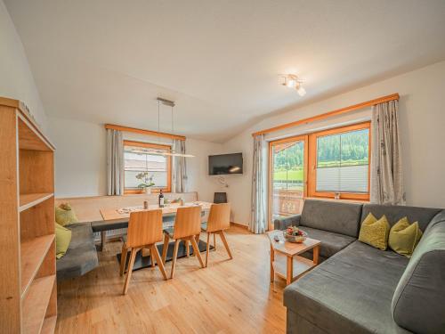 a living room with a couch and a table at Appartements Gamper - Alpline Appartements KG in Brixen im Thale