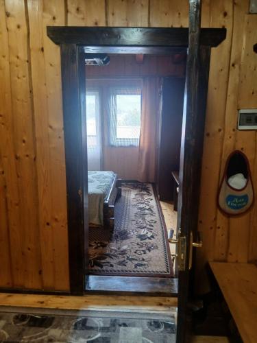 a door into a room with a bed in it at Верх Довбуша in Vorokhta
