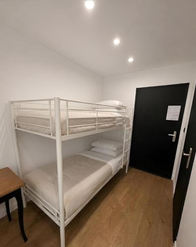 a bunk bed room with two bunk beds and a table at Sublime Sanary plage in Sanary-sur-Mer