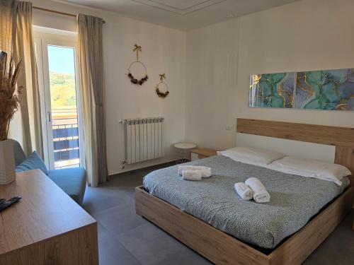 a bedroom with a bed with two towels on it at VeraLuce in Caltavuturo