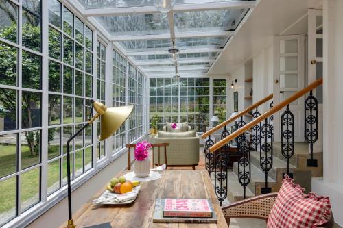 a room with a glass ceiling and a table at Singell Tea Estate - A CGH Earth Experience in Darjeeling