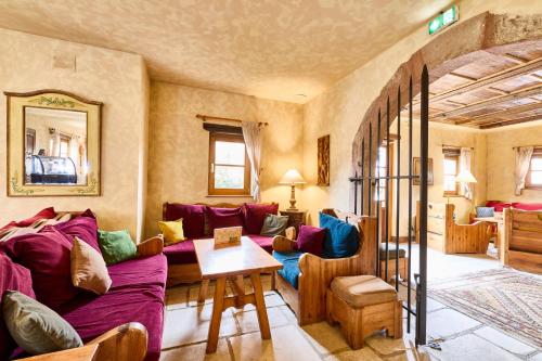 a living room with a couch and a table at Logis Hotel Domaine de Rouffach in Rouffach