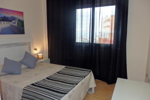 En eller flere senge i et værelse på MEDDAYS APARTAMENTO MAR DE LAURIA