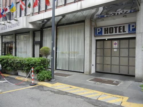 a hotel building with two garage doors in a street at Delle Nazioni Milan Hotel in Milan