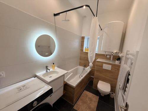 a bathroom with a sink and a tub and a toilet at Superbe 4 pièces luxueux in Fleury-les-Aubrais