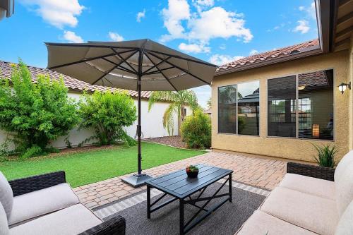 a patio with a table and an umbrella at Getaway at Power Ranch in Gilbert