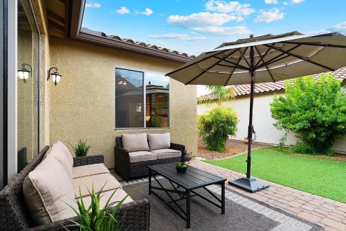 a patio with a table and an umbrella at Getaway at Power Ranch in Gilbert