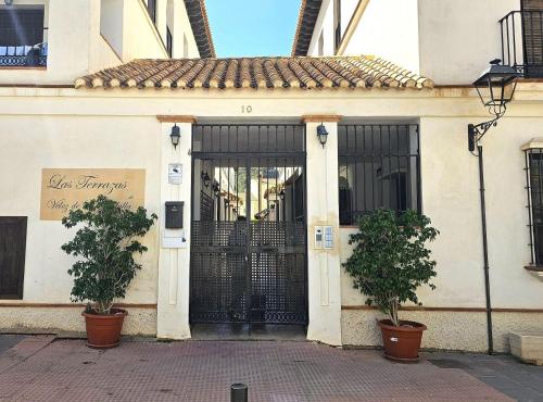 a entrance to a building with a black gate at Casa Velez in Vélez de Benaudalla