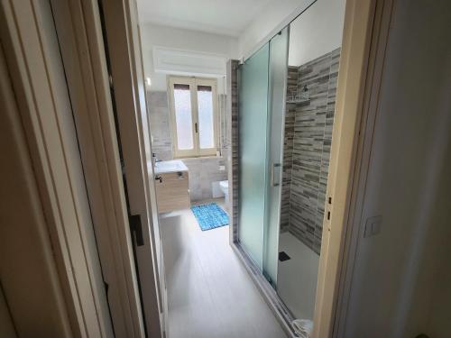 a bathroom with a walk in shower and a glass door at Casa MedeFaby Due in S'archittu Cuglieri