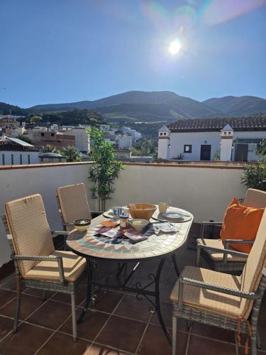 a patio with a table and chairs on a balcony at Casa Velez in Vélez de Benaudalla