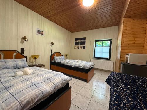 a bedroom with two beds and a window at Monteur Budget Zimmer in Schöppenstedt
