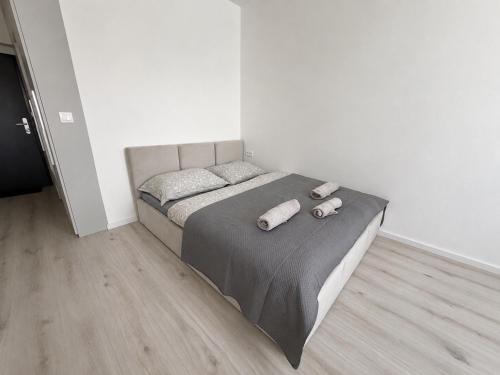 a bed with two pillows on it in a bedroom at Luxury White Residence in Trenčín