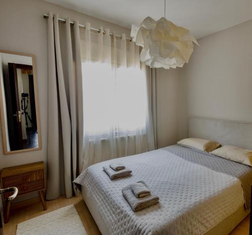 a bedroom with a bed with two towels on it at Konitsa Valley in Konitsa