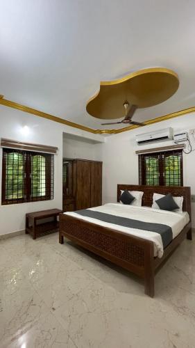 a bedroom with a large bed with a ceiling at Sangeetha Private Pool Villa in Auroville