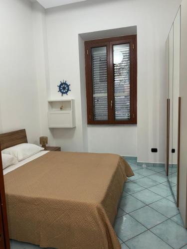 a bedroom with a bed and a window at Sibilla Flegrea in Pozzuoli