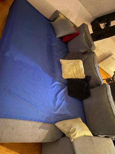 a blue bed with pillows on top of it at Cœur de Troyes studio in Troyes