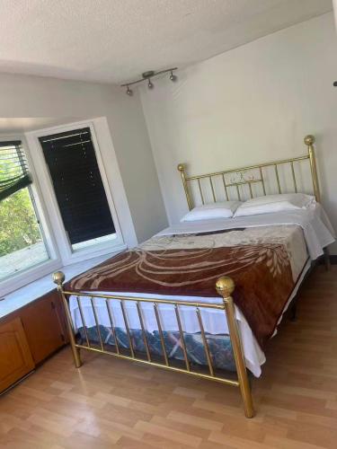 a bedroom with a bed in a room with a window at six bedroom house in Victoria