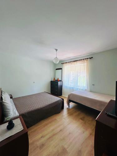 a hotel room with two beds and a window at Mollys apartment 1 in Pogradec