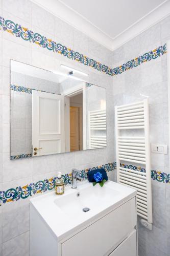 a bathroom with a white sink and a mirror at Villa La Panoramica Sea View in Capri
