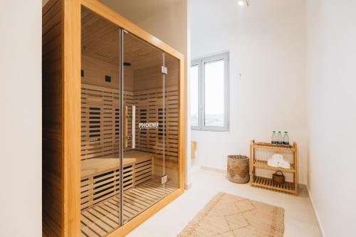 a glass shower in a bathroom with white walls at Ritrovare Country House in Citta' Sant'Angelo