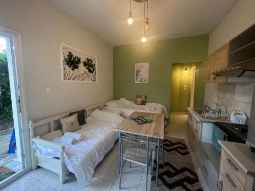 a room with a bed and a table in a kitchen at Olive in Keramoti