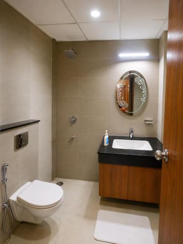 a bathroom with a toilet and a sink and a mirror at Velvet stay in Lucknow