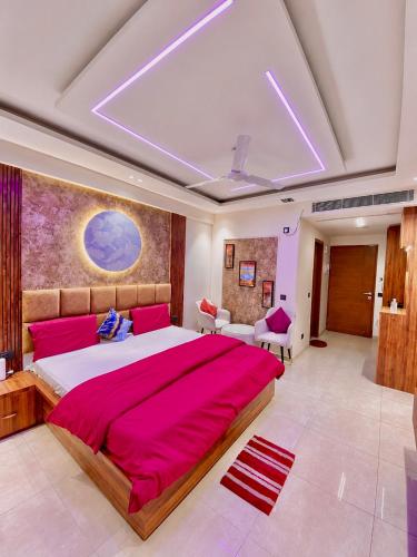 a large bedroom with a large bed with red sheets at Velvet stay in Lucknow