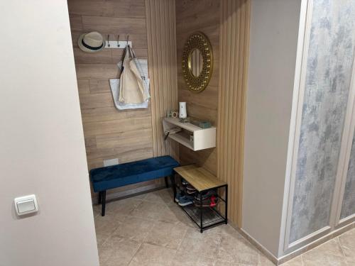 a small bathroom with a sink and a blue stool at Sun Sea Resort in Ravda