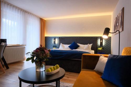 a hotel room with a bed and a table at Landhaus Lauble in Hornberg