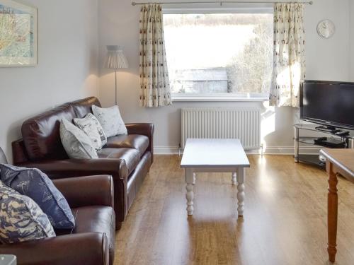 a living room with a couch and a table at Buzzards - 8235 in Bridport