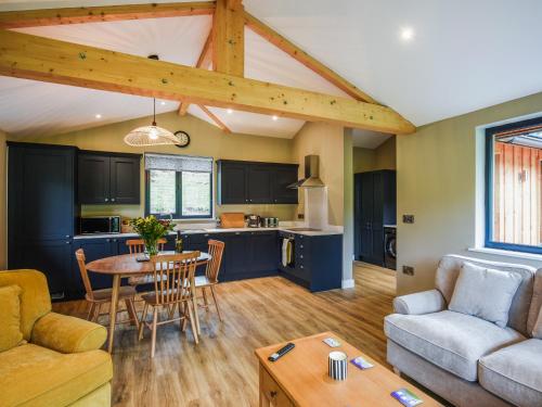 a kitchen and living room with a couch and a table at Poplar Lodge - Uk50625 in Welshpool