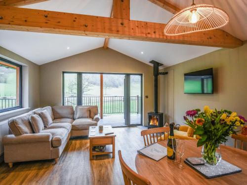 a living room with a couch and a table at Poplar Lodge - Uk50625 in Welshpool