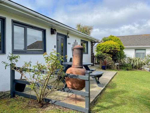 a large vase sitting outside of a house at Fistral in Saint Merryn