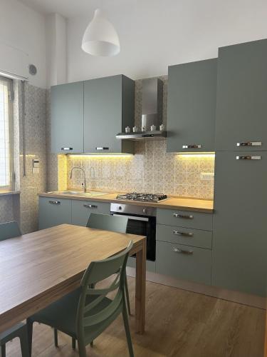 a kitchen with a wooden table and a wooden dining table at La Terrazza d'Abruzzo in Guardiagrele
