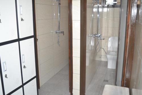 a bathroom with a shower and a toilet at jPALACE in Bonamoussadi