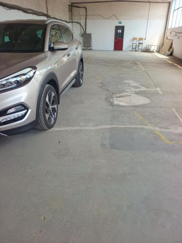 a silver car parked in a parking lot at parcare privata doar pentru autoturisme in Braşov