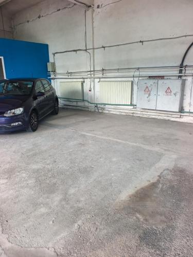 a parking garage with a car parked in it at parcare privata doar pentru autoturisme in Braşov
