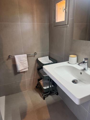 a bathroom with a white sink and a mirror at Résidence Figarella in Propriano