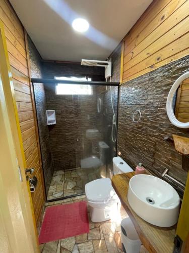 a bathroom with a toilet and a sink and a shower at Swiss Chalets - Thermas Water Park in Águas de São Pedro