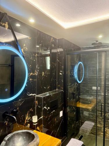 a bathroom with a sink and a mirror at LefkoParga Luxury Suites in Parga