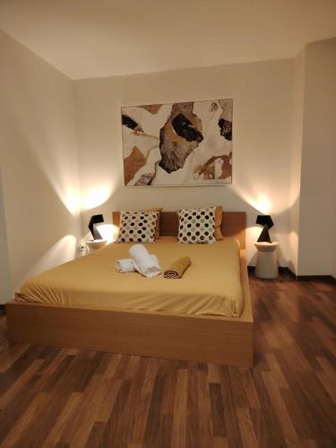 a bedroom with a large bed with two pillows at Le Bullière 60m2 plein centre parking inclus! in Rodez