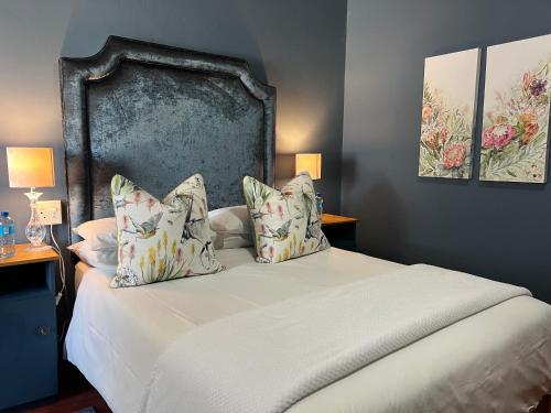 a bedroom with a large bed with two pillows at Kamieskroon Hotel in Kamieskroon
