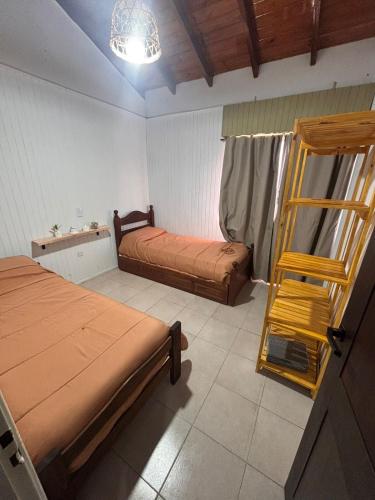 a bedroom with two beds and a ladder in it at Casa en Berazategui in Plátanos